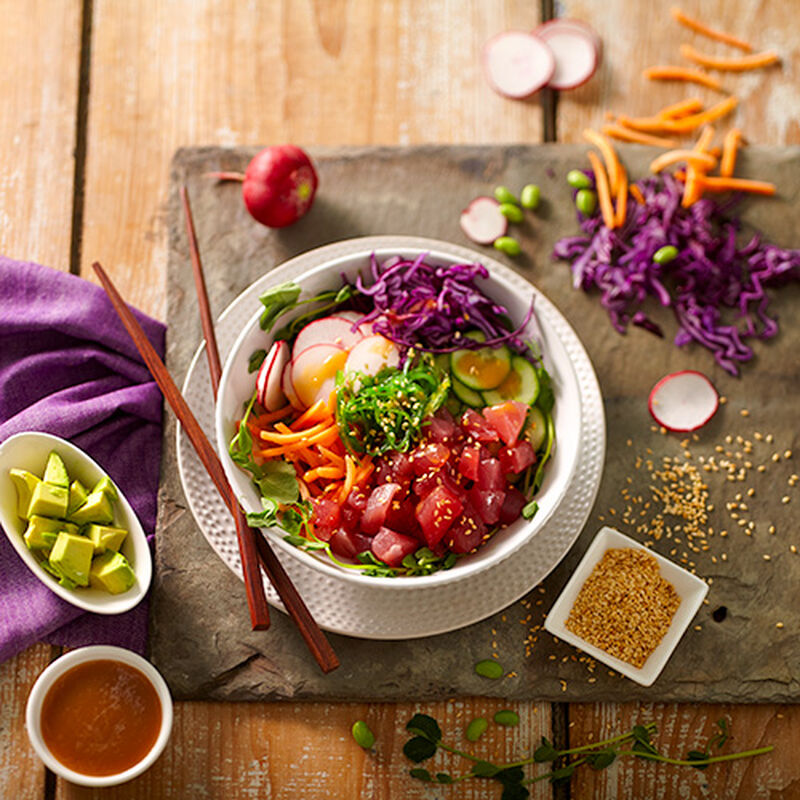 A salad consisting of chopped raw salmon and various vegetables. 