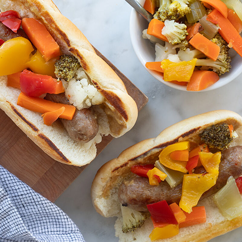 Grilled sausages in hoagie rolls topped with a giardiniera blend. 